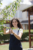 smiling young woman gardener with curly