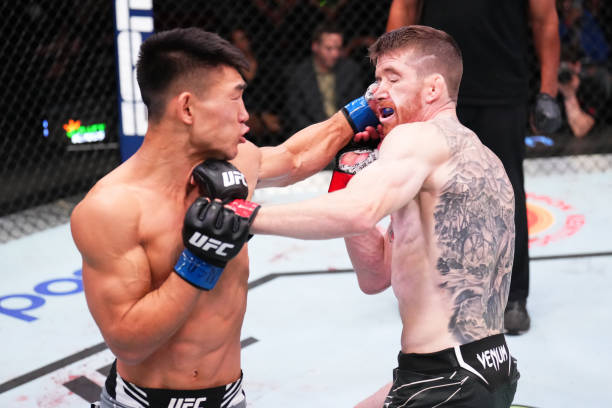 Song Yadong of China punches Cory Sandhagen in a bantamweight fight during the UFC Fight Night event at UFC APEX on September 17, 2022 in Las Vegas,...