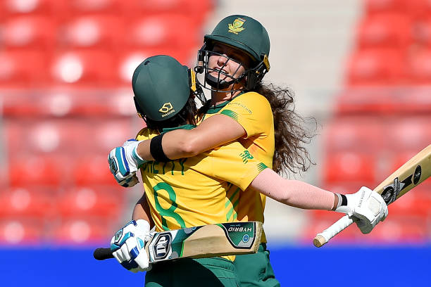 South Africa's batswoman Laura Wolvaardt celebrates reaching her half century with teammate Trisha Chetty during the Twenty20 women's World Cup...