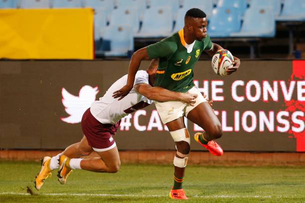 South Africa's wing Aphelele Fassi (R) runs to score a try as he is tackled by Georgia's wing Demur Tapladze (L) during the first rugby union Test match between South Africa and Georgia at Loftus Versfeld stadium in Pretoria on July 2, 2021. (Photo by PHILL MAGAKOE / AFP) (Photo by PHILL MAGAKOE/AFP via Getty Images)