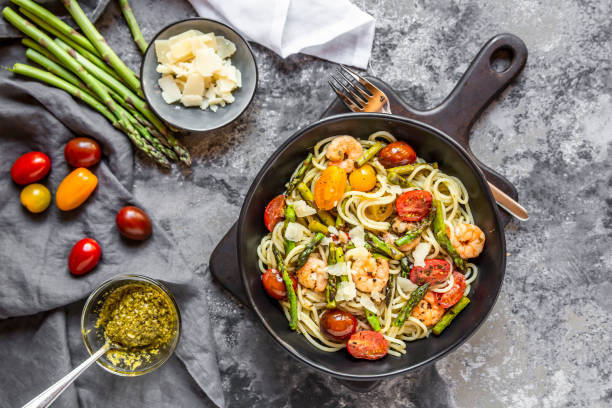 spaghetti with shrimps green asparagus tomato pesto and parmesan picture