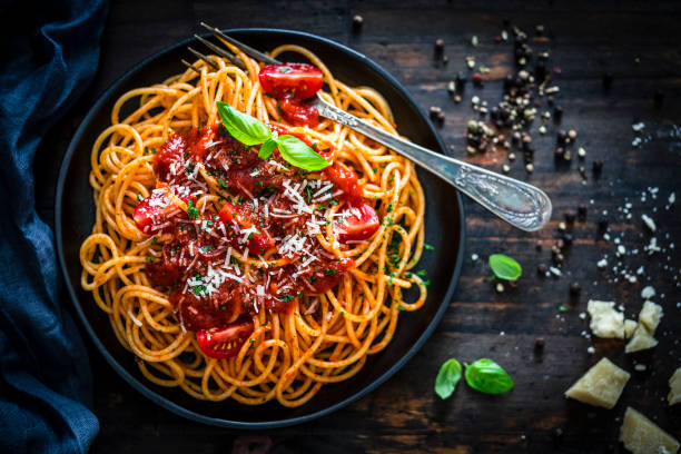 spaghetti with tomato sauce shot on rustic wooden table picture