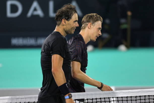 Spain's Rafael Nadal walks with Canada's Denis Shapovalov during the third-place play-off match of the Mubadala World Tennis Championship in the Gulf...