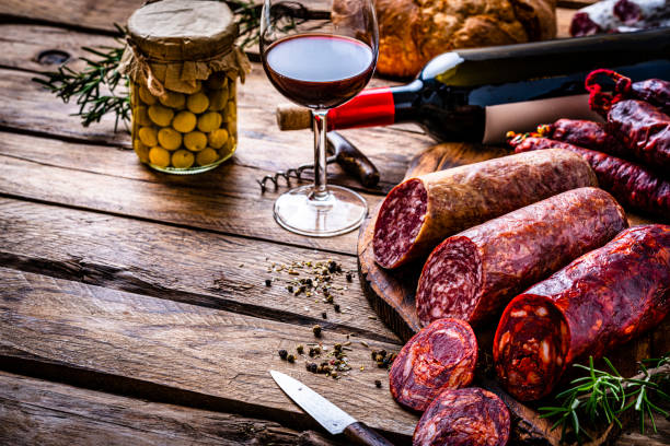 spanish sausages and wine on wooden table picture