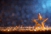 Sparkling Golden Christmas Star - Ornament Decoration Defocused Bokeh Background