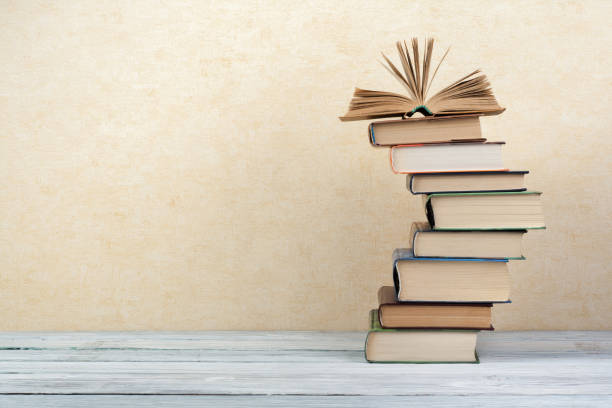 Stack of colorful books. Education background. Back to school. Book, hardback colorful books on wooden table. Education business concept. Copy space for text