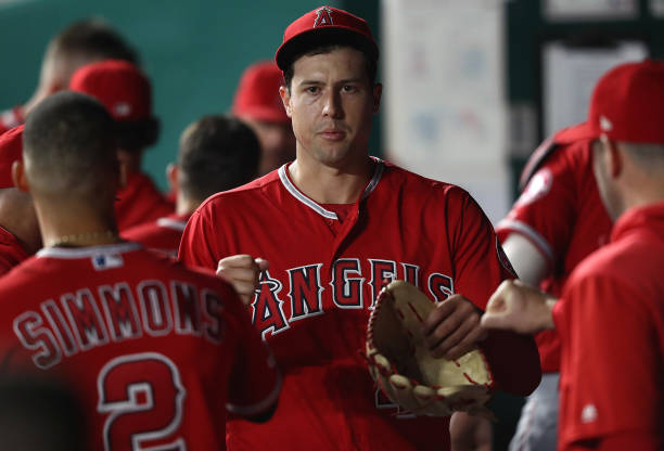 Starting pitcher Tyler Skaggs of the Los Angeles Angels is congratulated by teammates in the dugout after striking out Ryan O'Hearn of the Kansas...