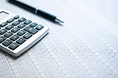 Statistics, calculator and ballpoint pen. Financial business calculation.