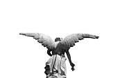 Statue of a winged angel photographed from behind