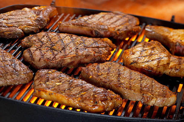 steak and pork chops on grill picture