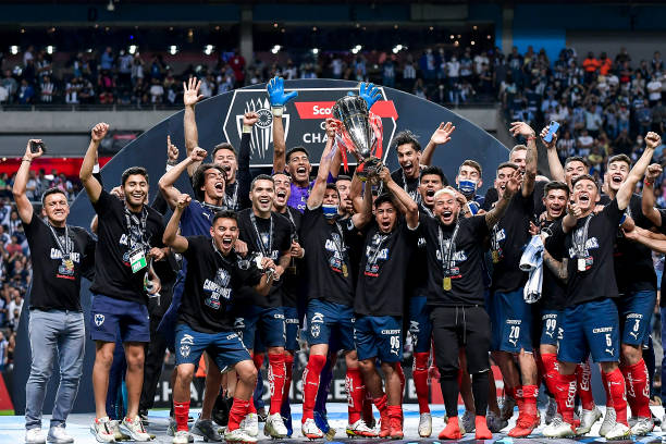 Stefan Medina and Neder Hernándz of Monterrey lift the trophy after their team's victory in the final match of CONCACAF Champions League 2021 between...