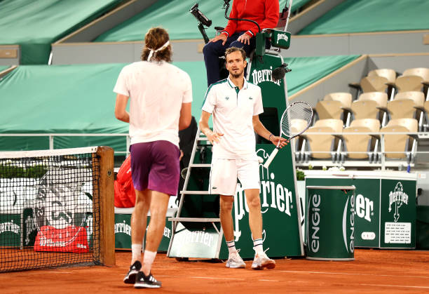 Stefanos Tsitsipas of Greece is congratulated by Daniil Medvedev of Russia after their mens singles quarter final match during day ten of the 2021...