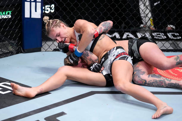 Stephanie Egger of Switzerland punches Jessica-Rose Clark of Australia in their bantamweight fight during the UFC Fight Night event at UFC APEX on...