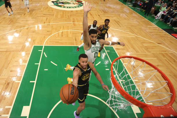 Stephen Curry of the Golden State Warriors drives to the basket against Jayson Tatum of the Boston Celtics in the first half during Game Four of the...