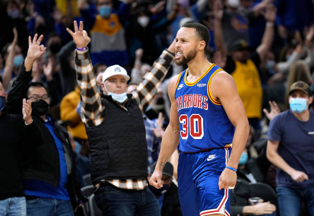 Stephen Curry of the Golden State Warriors reacts after making a three-point shot against the Memphis Grizzlies during the fourth quarter at Chase...