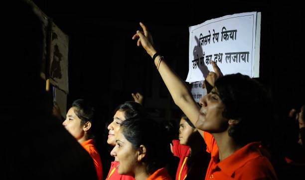 Students and teachers shout slogans during the 'Meri Raat Meri Sadak' campaign in which thousands of girls and boys from Parishkar College too