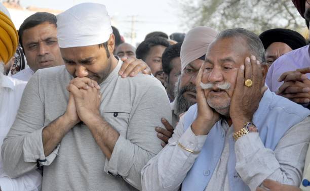 Sufi Singer Padma Shri Ustad Puran Chand Wadali and his son Singer Lakhwinder Wadali weep during cremation of his younger brother Pyarelal Wadali at..