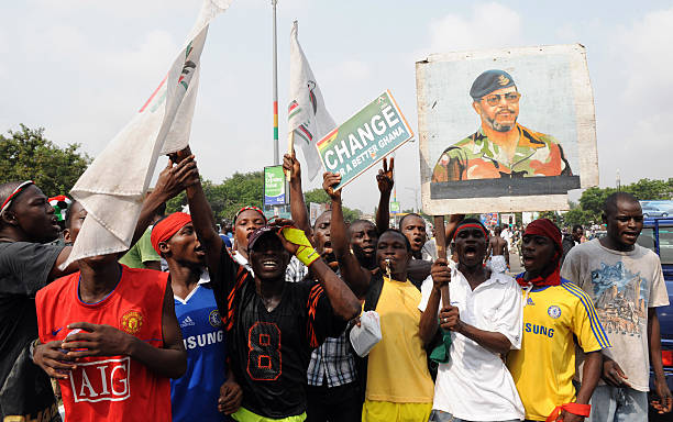 Supporters of the opposition National Democratic Congress protest carries a poster of founder of the party Jerry Rawlings at main gate leading to the...