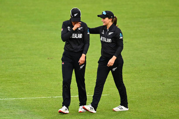 Suzie Bates and Amelia Kerr of New Zealand leave the field after losing the 2022 ICC Women's Cricket World Cup match between New Zealand and England...