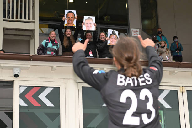 Suzie Bates of New Zealand reacts to her Otago Sparks domestic teammates after winning the 2022 ICC Women's Cricket World Cup match between New...