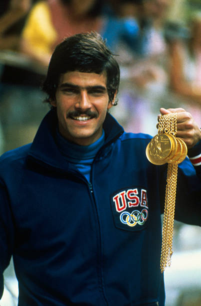 swimmer-mark-spitz-proudly-displays-the-five-gold-medals-he-won-in-picture-id515293192