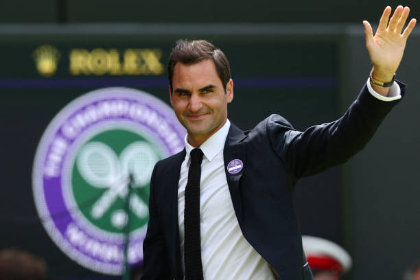 Swiss tennis player Roger Federer waves during the Centre Court Centenary Ceremony, on the seventh day of the 2022 Wimbledon Championships at The All...