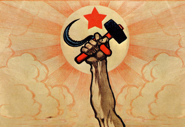 The hand wielding the hammer and sickle, in the background the rising sun and the red star . Color lithograph. Digital optimization from detail of a...