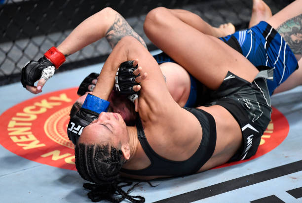 Taila Santos of Brazil secures a rear choke submission against Joanne Wood of Scotland in a flyweight fight during the UFC Fight Night event at UFC...