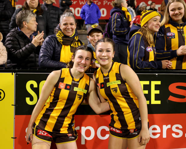 Tamara Smith and Charlotte Baskaran of the Hawks pose for a photo with fans during the round seven AFLW match between the Hawthorn Hawks and the Port...