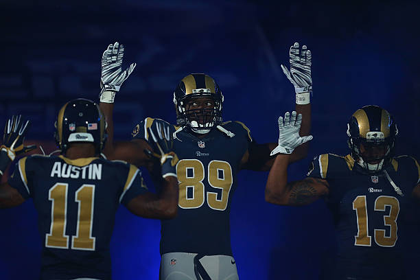 Tavon Austin, Jared Cook, Chris Givens of the St. Louis Rams pay homage to Mike Brown by holding their hands up during their pre-game introduction...
