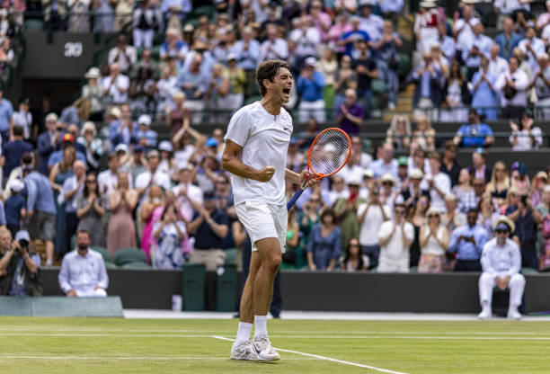 Taylor Fritz celebrates winning the match against Jason Kubler on day eight of the 2022 Wimbledon Championships at the All England Lawn Tennis and...
