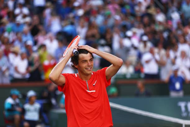 Taylor Fritz of the United States celebrates to the crowd after his straight sets victory against Rafael Nadal of Spain in the men's Final on Day 14...