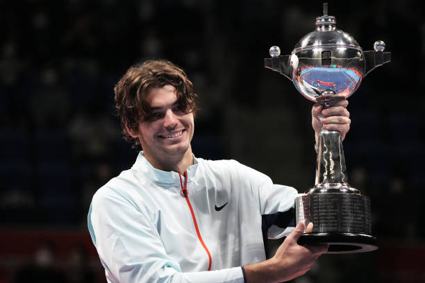 Taylor Fritz of the United States poses with the trophy after defeating Frances Tiafoe of the United States in the singles final game on day seven of...