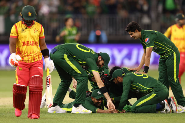 Team mates get around Babar Azam of Pakistan after taking a catch to dismiss Regis Chakabva of Zimbabwe during the ICC Men's T20 World Cup match...