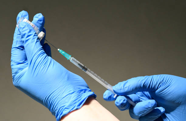 Team member of a mobile a Covid-19 vaccination station in a shopping mall fills a syringe with the BioNtech Pfizer vaccine in Ludwigsburg, southern...