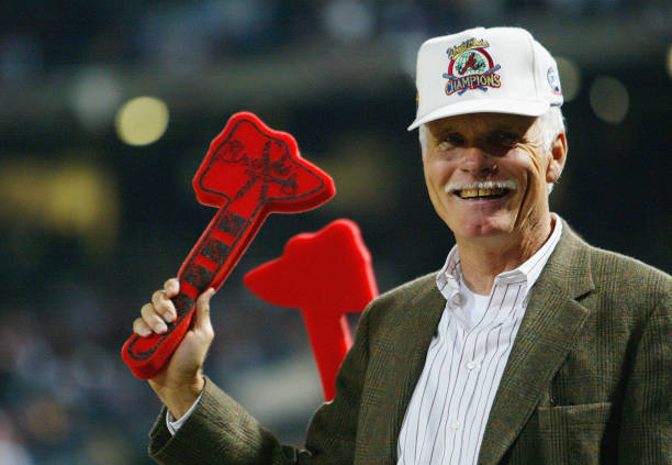 Ted Turner does the tomahawk chop during Game 1 of the National League Division Series between the Chicago Cubs and the Atlanta Braves on September...