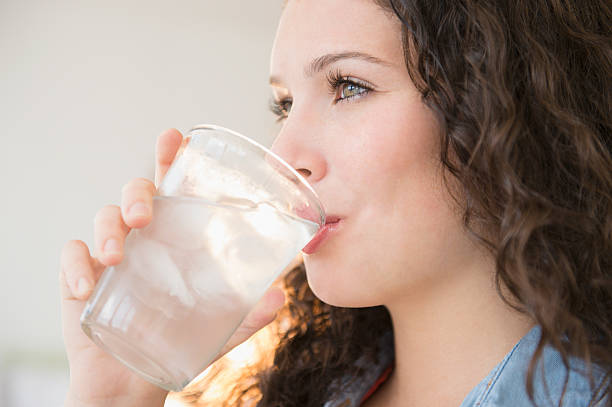 teenage girl drinking water - drinking water stock pictures, royalty-free photos & images
