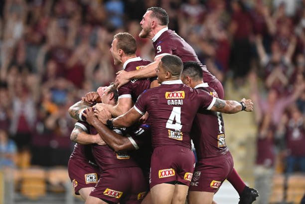 The Maroons celebrate after defeating the Blues during game three of the State of Origin series between the Queensland Maroons and the New South...