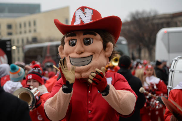 The mascot for the Nebraska Cornhuskers lead the team to the stadium before the game against the Michigan State Spartans at Memorial Stadium on...