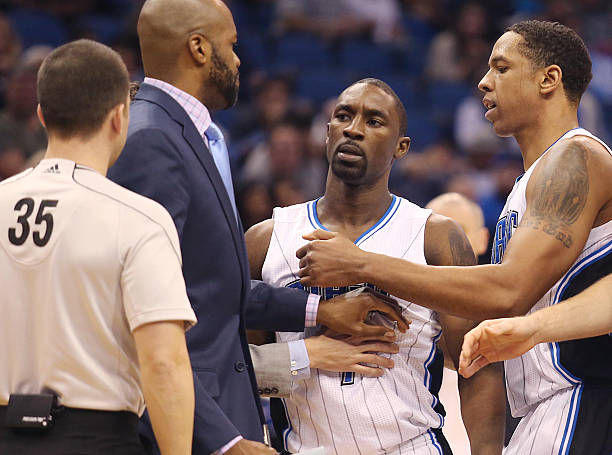 The Orlando Magic's Ben Gordon, middle, is held back by teammate Channing Frye, right, after Gordon was called for a technical foul by game official...