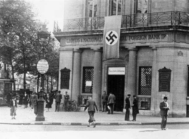 The Paris branch of the British Lloyds Bank with a swastika hanging over its door after being converted into a German bank during the Nazi occupation...