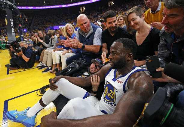 The Warriors Draymond Green bowled over a courtside videographer as he chased a second quarter loose ball. The Boston Celtics visit the Golden State...