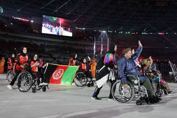 This photo taken on October 6, 2018 shows the Afghanistan team parade out during the opening ceremony of the 2018 Asian Para Games at the Gelora Bung...