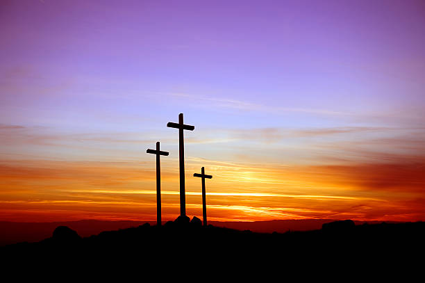three crosses standing at the sunset - good friday stockfoto's en -beelden