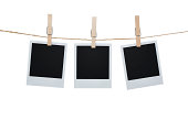 Three Polaroid pictures hanging on a clothesline with pins