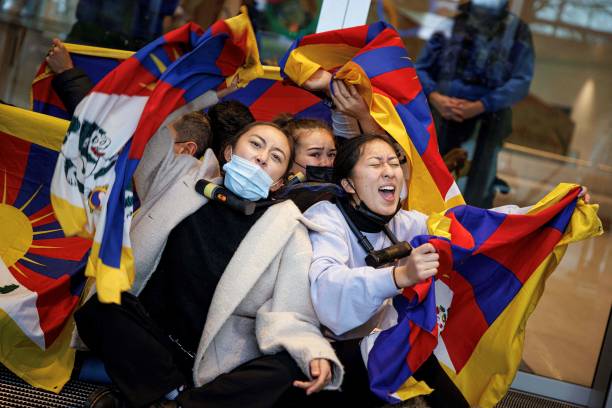 Tibetan activists from the Students for a Free Tibet association, as they perform a sit in at the entrance of the International Olympic Committee...