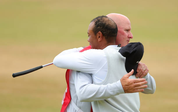 Tiger Woods of the United States and caddie Joe LaCava interact on the 18th green during Day Two of The 150th Open at St Andrews Old Course on July...