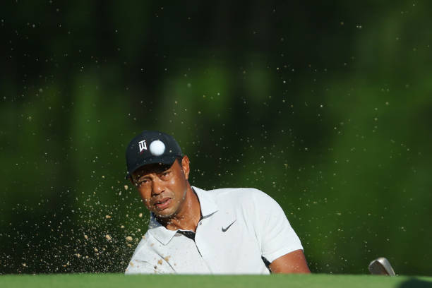 Tiger Woods of the United States plays a shot from a bunker during a practice round ahead of the start of the 2022 PGA Championship in Southern Hills...
