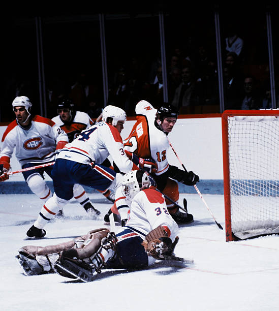 Tim Kerr of the Philadelphia Flyers looks for a loose puck during play against the Montreal Canadiens Circa 1980 at the Montreal Forum in Montreal,...
