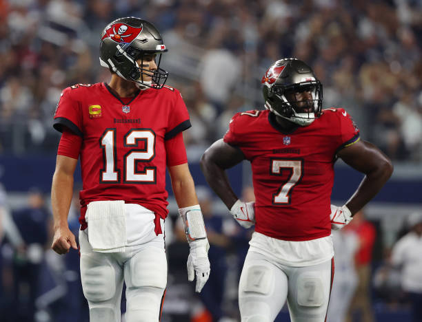 Tom Brady and Leonard Fournette of the Tampa Bay Buccaneers are seen on the field during the game against the Dallas Cowboys at AT&T Stadium on...